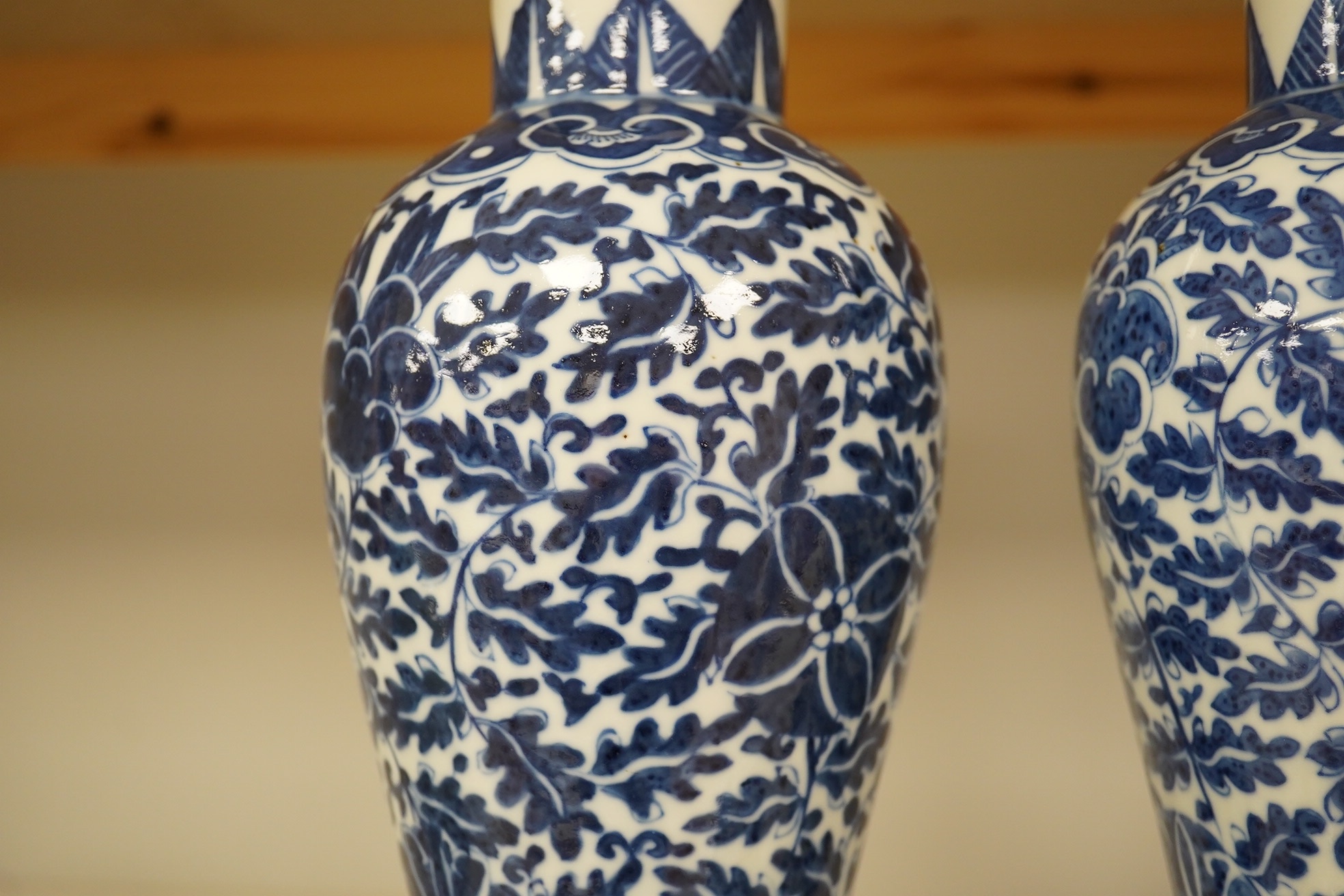 A pair of Chinese blue and white lotus decorated baluster vases and covers, late 19th century